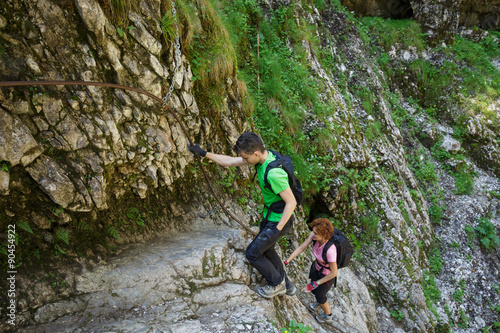 Hikers climbing on a safety cable