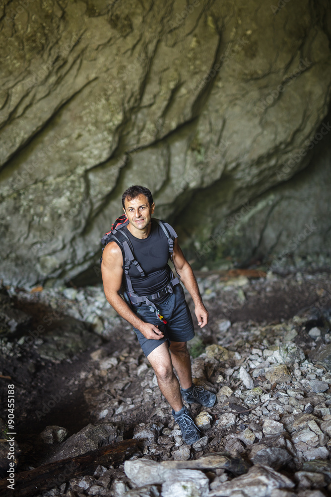 Man standing inside a cave Man standing inside a cave
