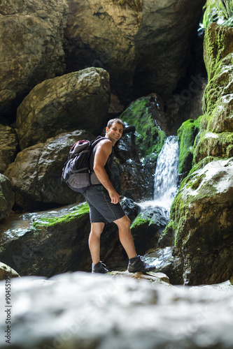 Hiker standing near a mountain river