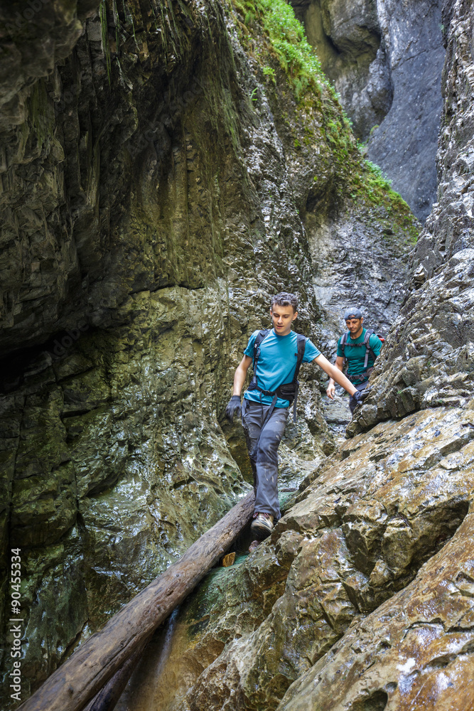 Two men hiker walking in a canyon