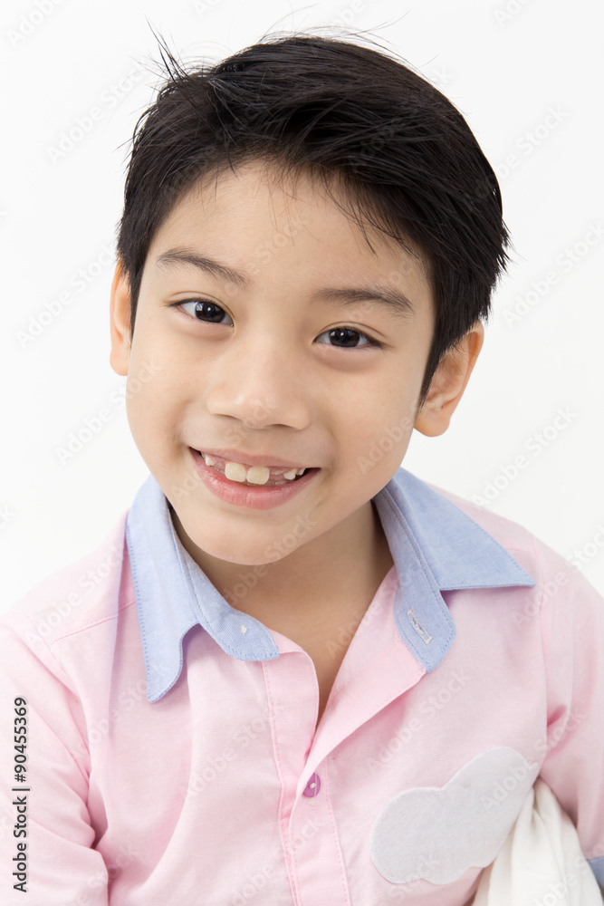 Little asian boy with smile face on gray background Little asian boy with smile face on gray background