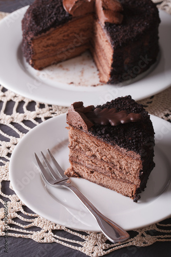 A piece of sliced dark chocolate cake close-up. vertical  
