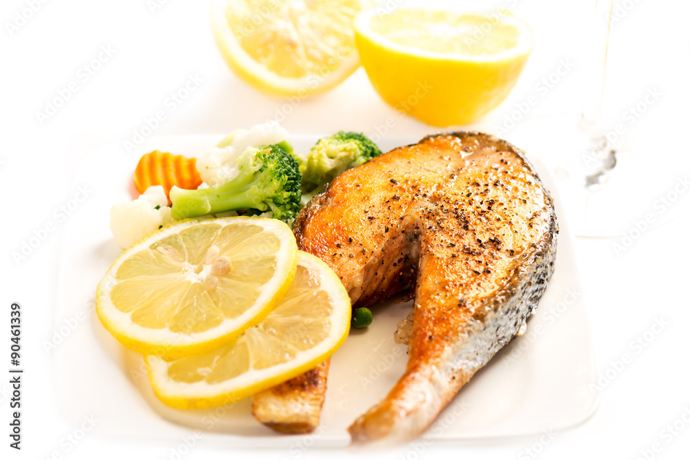 Grilled salmon and vegetables on white Grilled salmon and vegetables on white