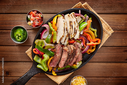 rustic fajita skillet meal with steak and chicken