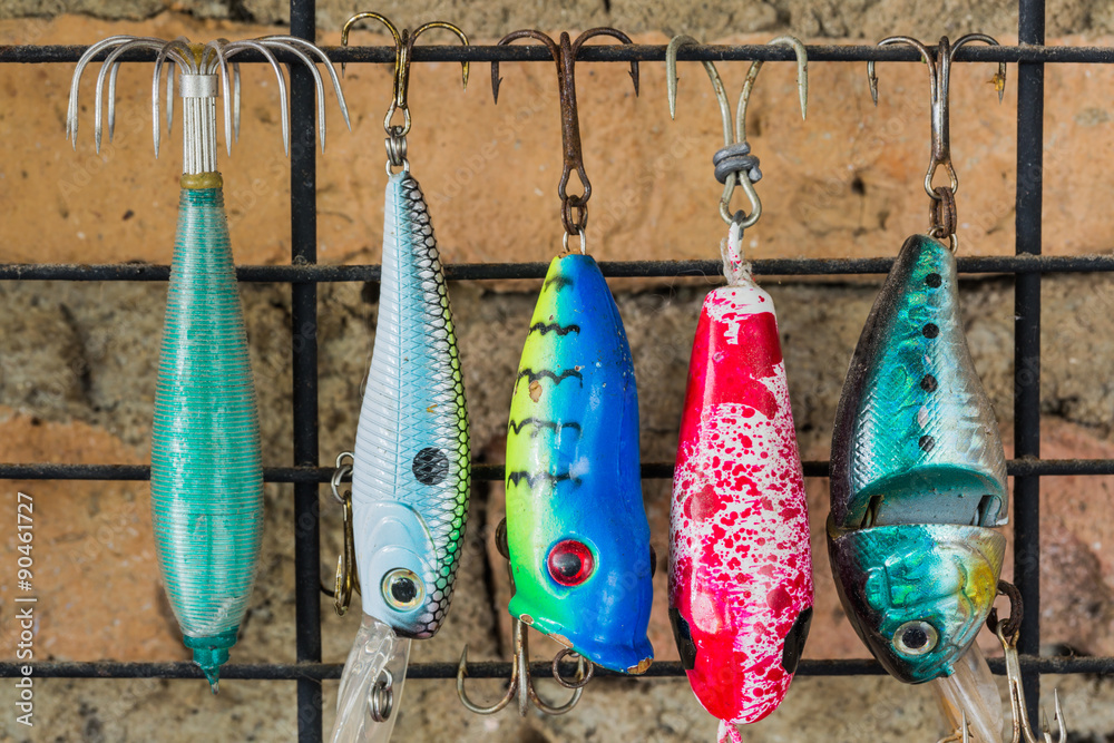 Old colorful fishing lure hanging on the wall Stock Photo