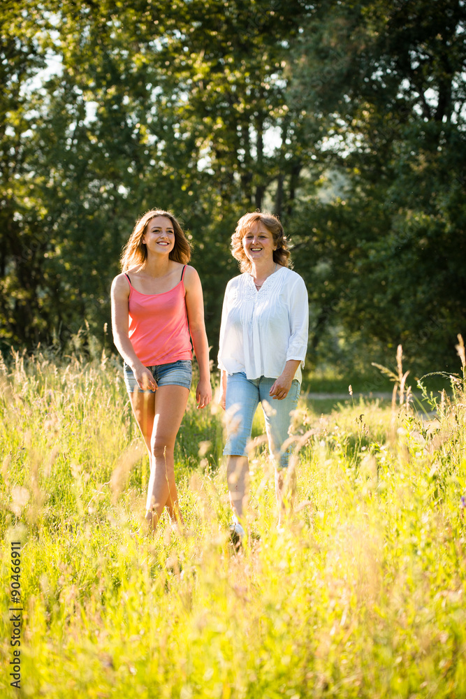 Mother and teenage daughter walk in nature Mother and teenage daughter walk in nature