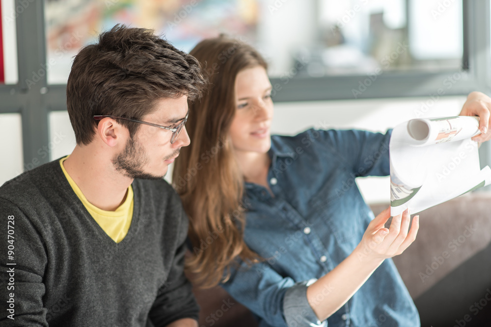 business team at office looking at a house plan business team at office looking at a house plan