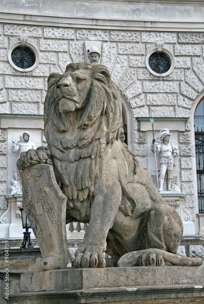 Statue of a lion with a shield at the entrance of Hofburg Palace, Vienna, Austria