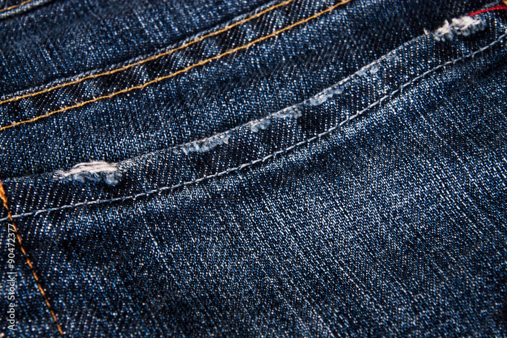 fashionable clothes. pile of jeans on a wooden background fashionable clothes. pile of jeans on a wooden background