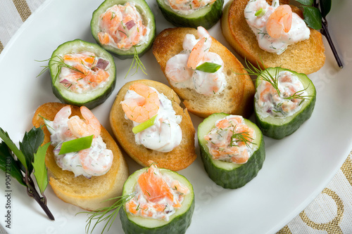 Fresh snack with salmon and shrimp on a plate