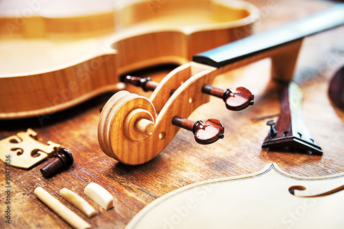 Elderly person building a violin photo