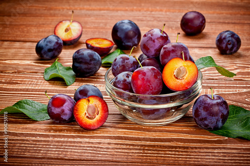 fresh plums on a wooden table