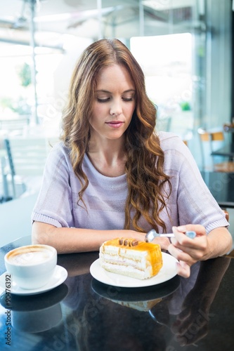 Pretty brunette enjoying a cake