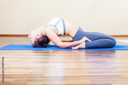 woman doing exercise of yoga indoor