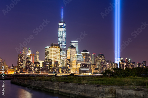 New York City Tribute in Light. The annual commemoration of September 11th in Lower Manhattan adjacent to the new World Trade Center. Two vertical columns of light rise above the Financial District.