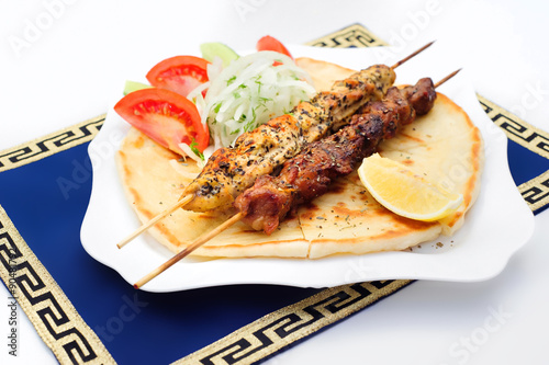 Souvlaki or kebab, grilled meat on pita bread with tomatoes and