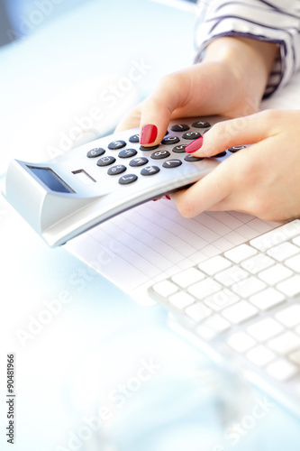 Businesswoman using calculator