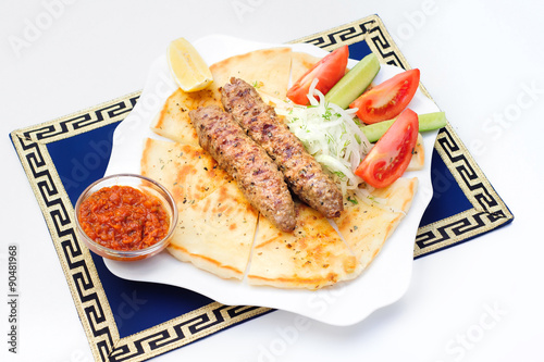 Souvlaki, kebab, grilled meat on pita bread with tomatoes and