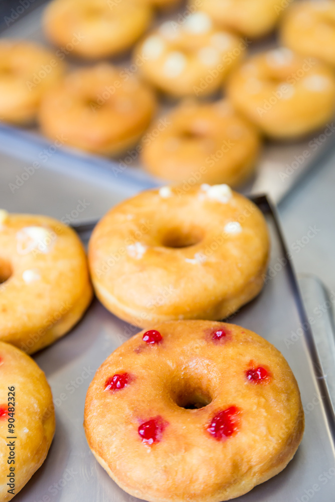 doughnuts with assorted filling on metal tray doughnuts with assorted filling on metal tray