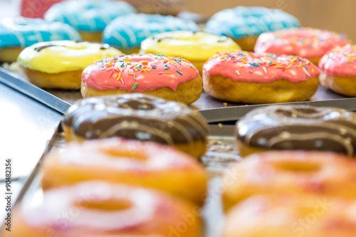 Fényképezés assorted glazed doughnuts in different colors
