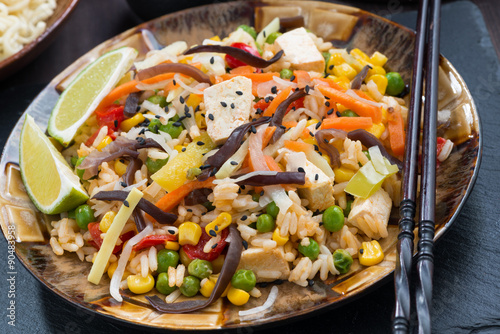asian lunch - fried rice with tofu and vegetables, close-up