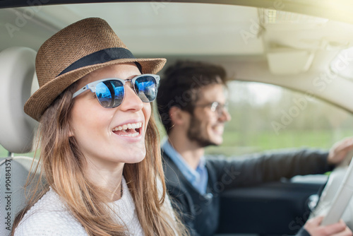 Young couple in his car, happy to drive on a country road © jackfrog