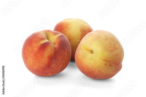 Three ripe peach on a white background