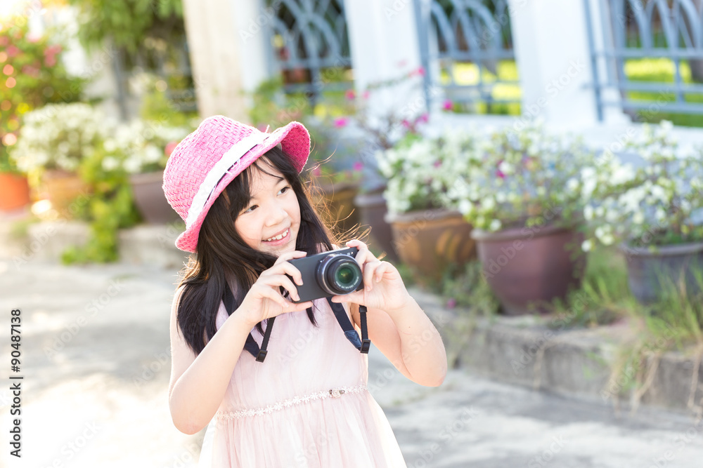 Little asian cute girl showing of camera and take a picture in p