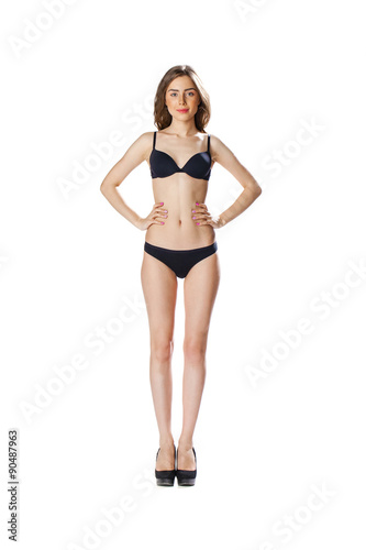 Full length portrait of a beautiful young model in black bikini