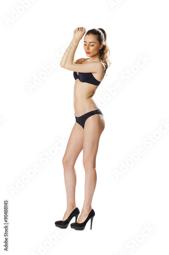Full length portrait of a beautiful young model in black bikini