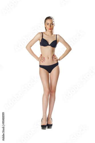 Full length portrait of a beautiful young model in black bikini