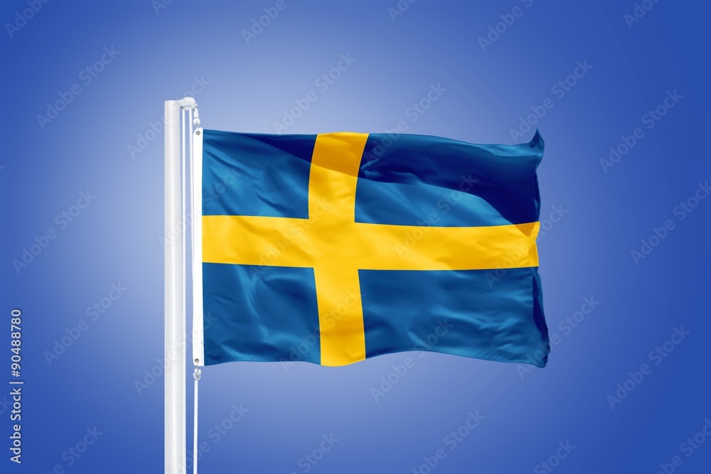 Flag of Sweden flying against a blue sky Flag of Sweden flying against a blue sky