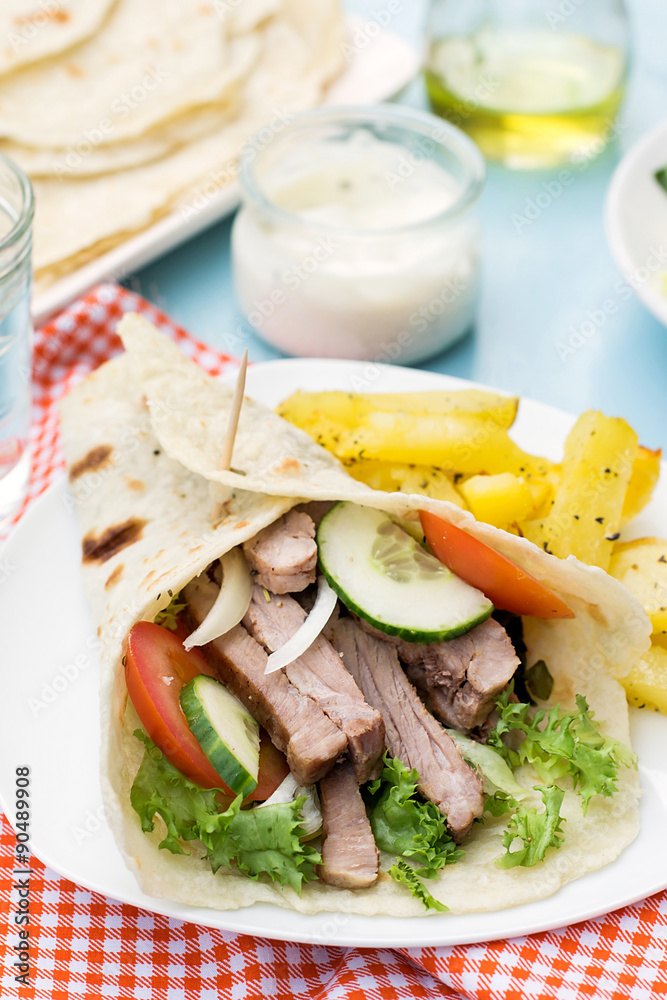 Greek gyros with pork, vegetables and homemade pita bread Greek gyros with pork, vegetables and homemade pita bread
