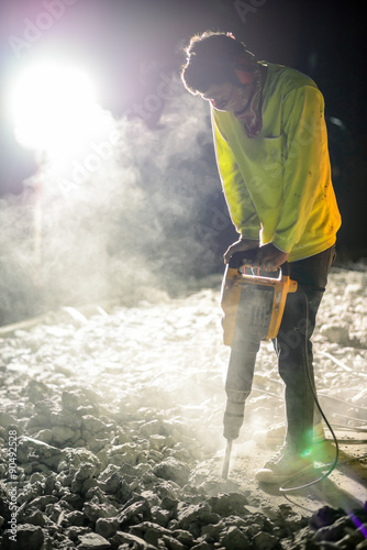 Road repairing works with jackhammer at night
