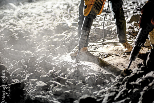 Road repairing works with jackhammer at night photo