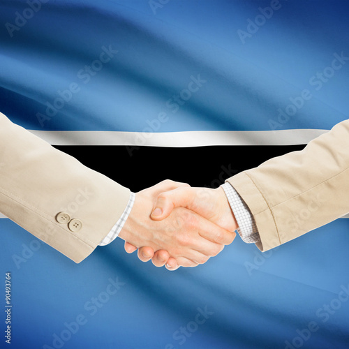 Businessmen handshake with flag on background - Botswana