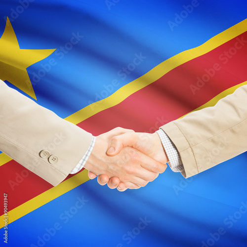 Businessmen handshake with flag on background - Democratic Repub