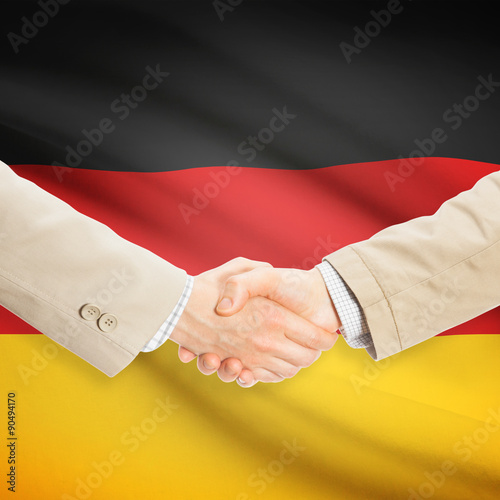 Businessmen handshake with flag on background - Germany