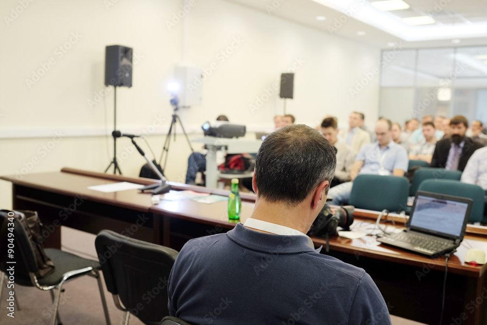 The audience listens to the acting in a conference hall