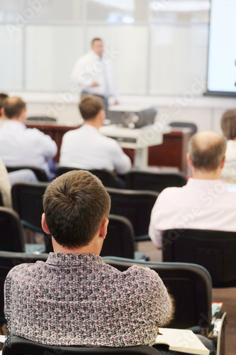 The audience listens to the acting in a conference hall