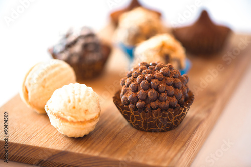 chocolate candies on the wooden plate