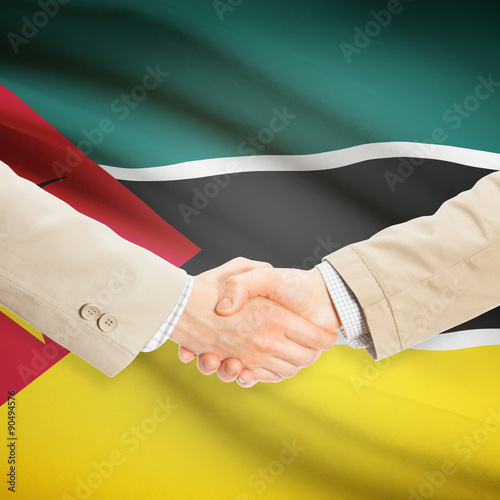 Businessmen handshake with flag on background - Mozambique