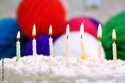 Birthday cake with candles on colorful background
