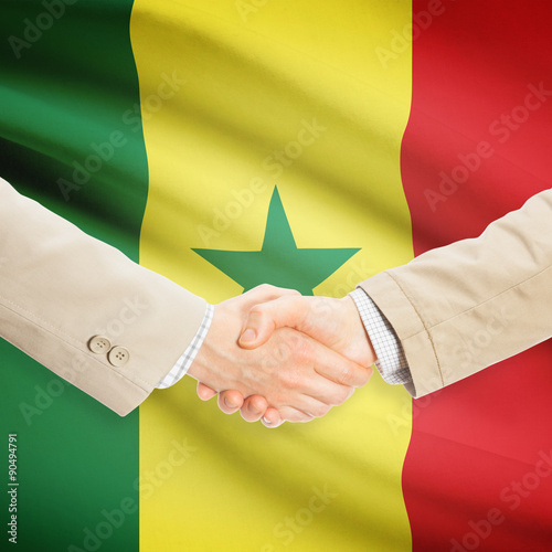 Businessmen handshake with flag on background - Senegal