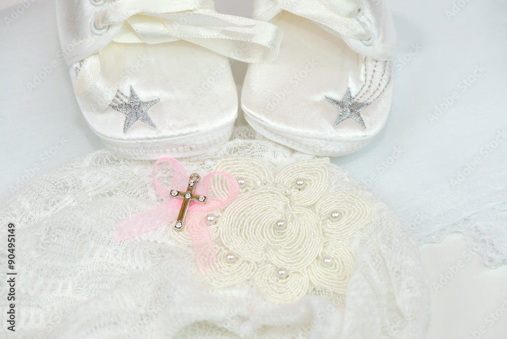 Baby shoes and cross for christening Baby shoes and cross for christening