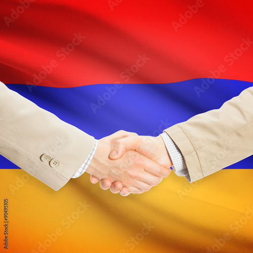 Businessmen handshake with flag on background - Armenia
