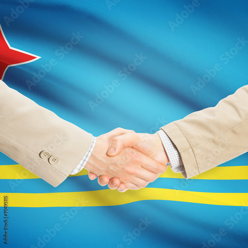 Businessmen handshake with flag on background - Aruba