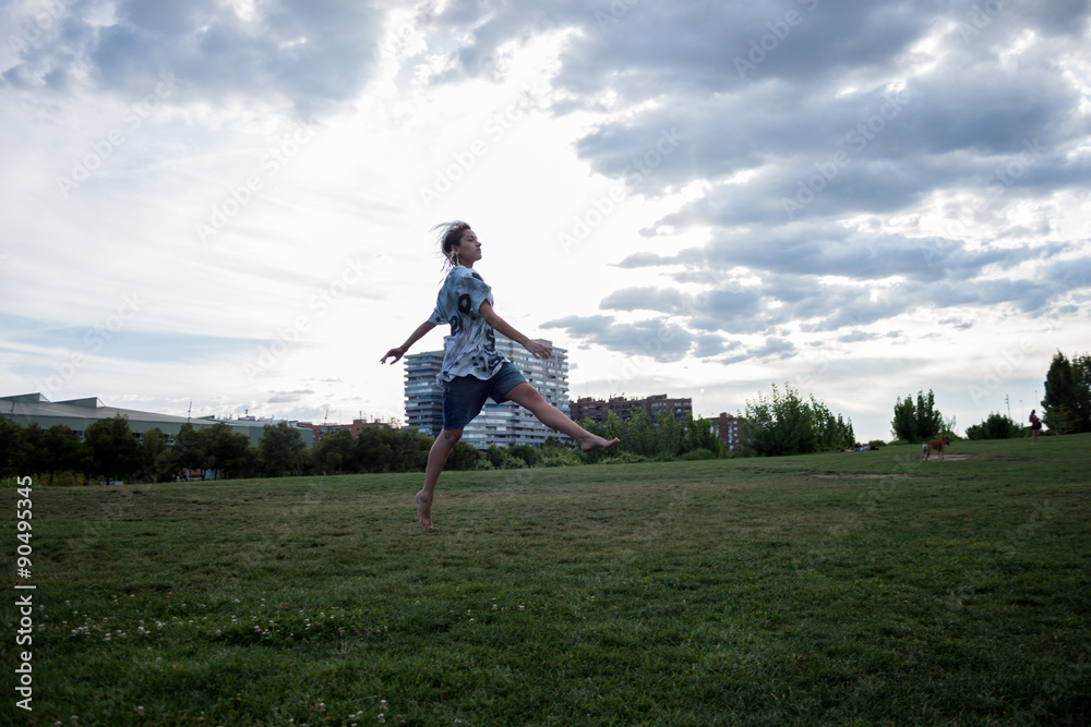 Latina woman jumping into the field.