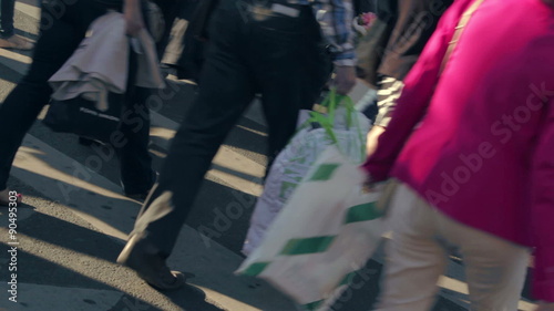 Pedestrians crossing the street during rush hour in a big city