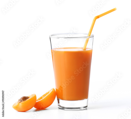 Glass of apricot juice isolated on white